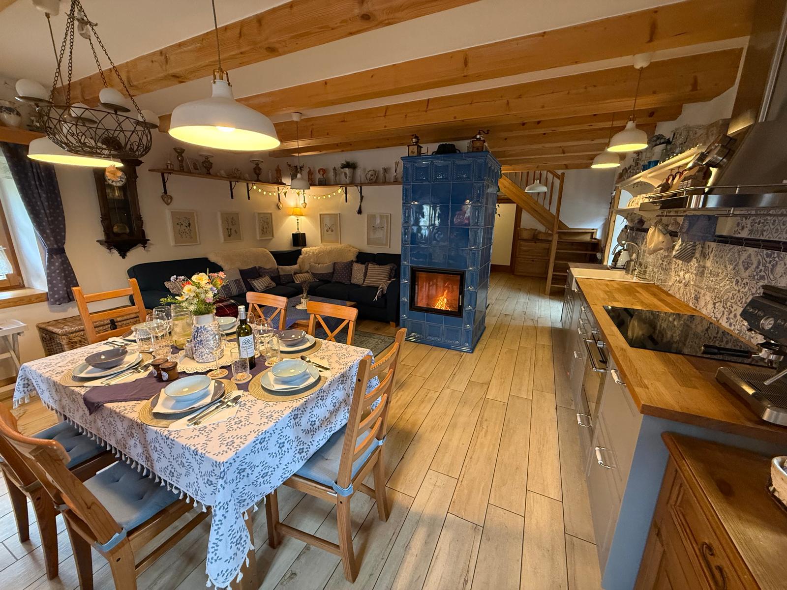 Living area with a tiled stove and dining space
