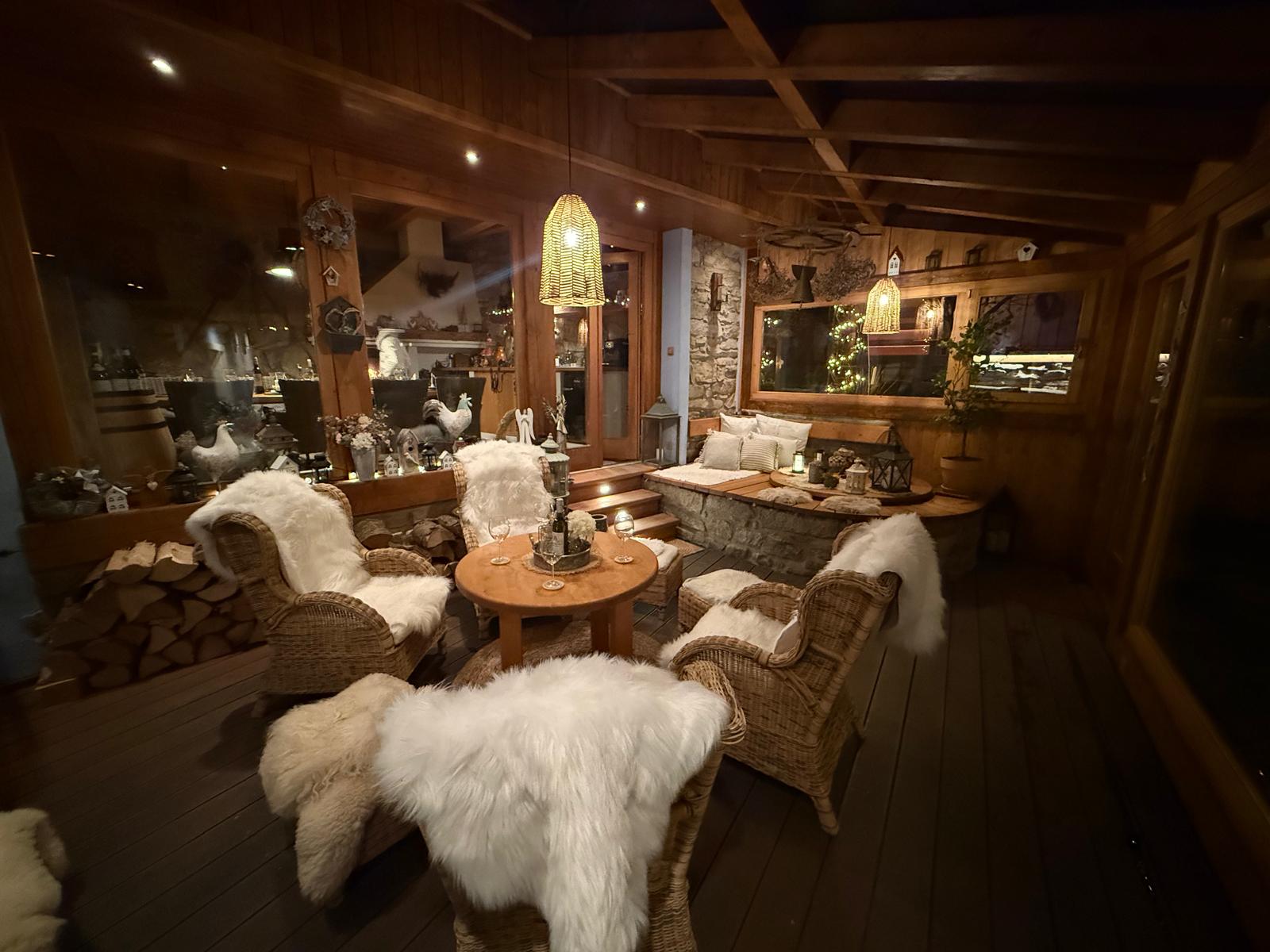 Garden room with sheepskin throws and fireplace
